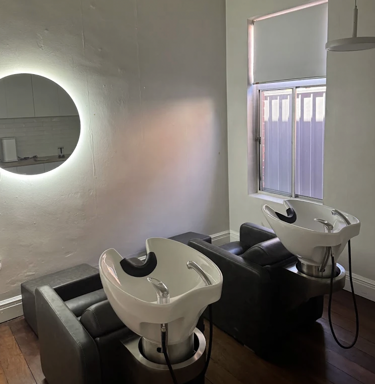 Commercial plumber Melbourne installing plumbing connections for salon wash basins