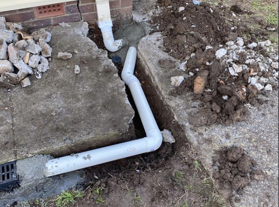 Plumber Melbourne inspecting exposed stormwater drainage pipework
