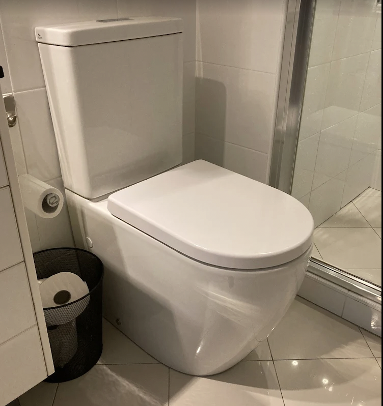 Plumber Melbourne repairing and installing a modern bathroom toilet